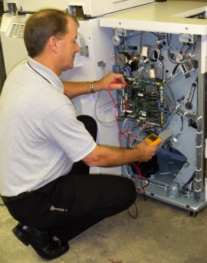 Technician servicing equipment